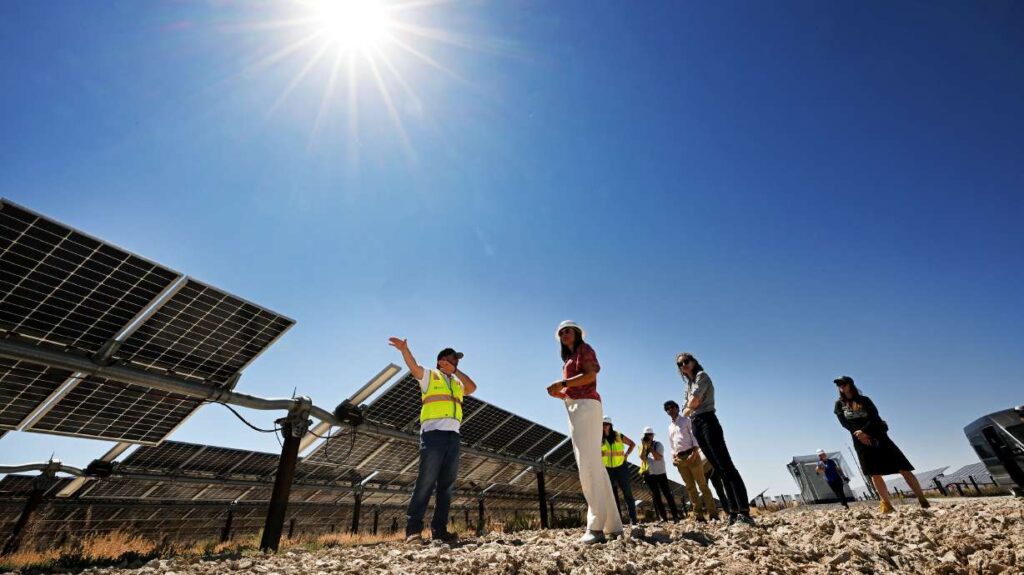 Brandon Terry, project manager from SOLV Energy, gives a tour of part of the facility to Salt Lake City Mayor Erin Mendenhall and other local officials as they open the Elektron Solar Project west of Grantsville in Tooele County on Monday.