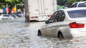 Electric car driving through a flood