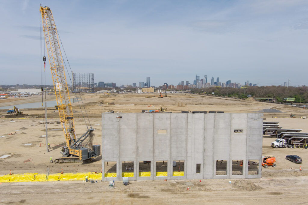 The first panels are erected for the “Bellwether District” as construction begins in April at the site of the former Philadelphia Energy Solutions oil refinery. Credit: HRP Group