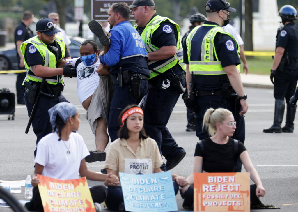 U.S. Capitol Police arrest a climate activist during a protest on Capitol Hill in 2021. Credit: Alex Wong/Getty Images