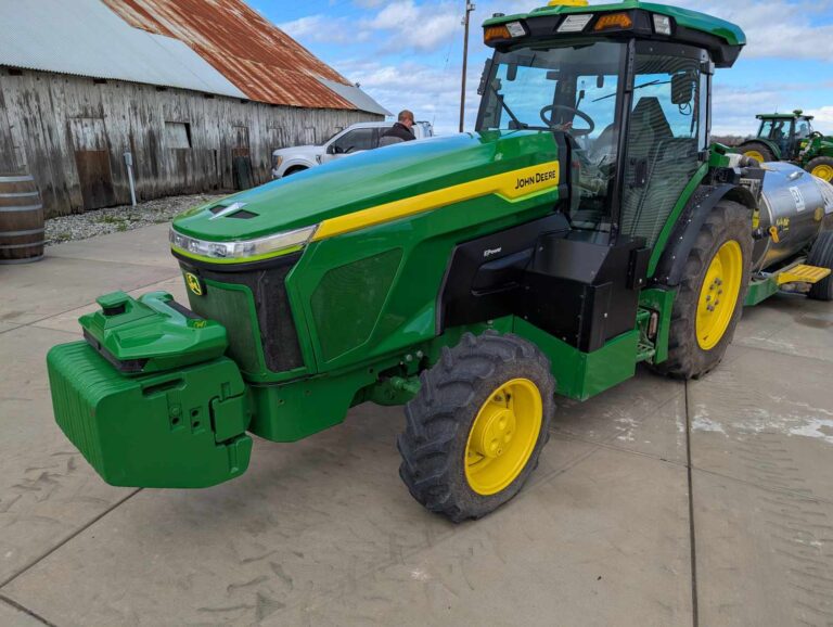 An E-Power tractor with orchard sprayer attachment.