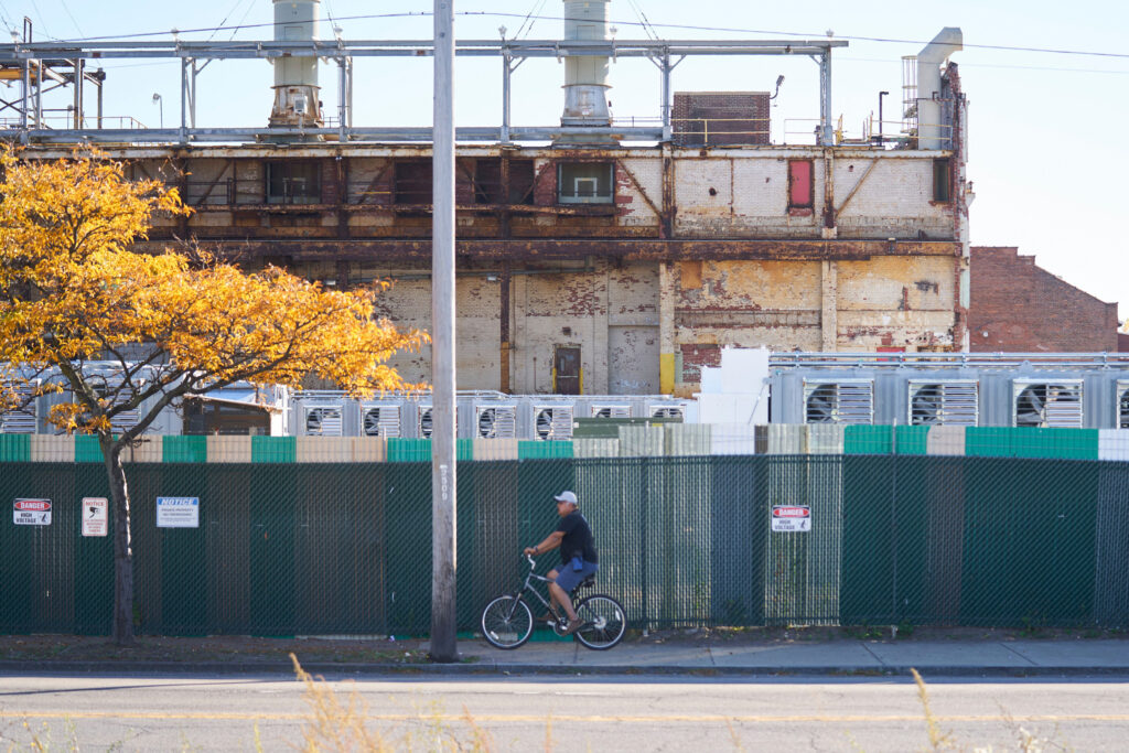A person rides their bike past the US Bitcoin facility on Oct. 24, 2022 in Niagara Falls, N.Y. Credit: Geoff Robins/AFP via Getty Images