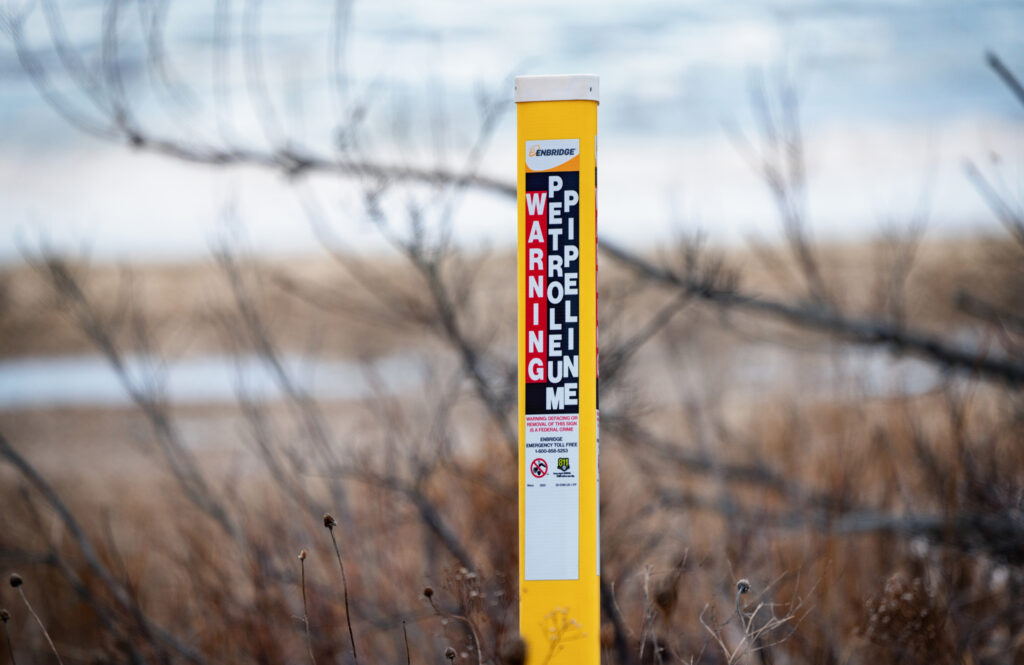 A pipeline marker is seen at the site of Enbridge Energy’s Line 5 near the Straits of Mackinac between Lake Michigan and Lake Huron. Credit: Tony Webster/CC BY 2.0 via Flickr
