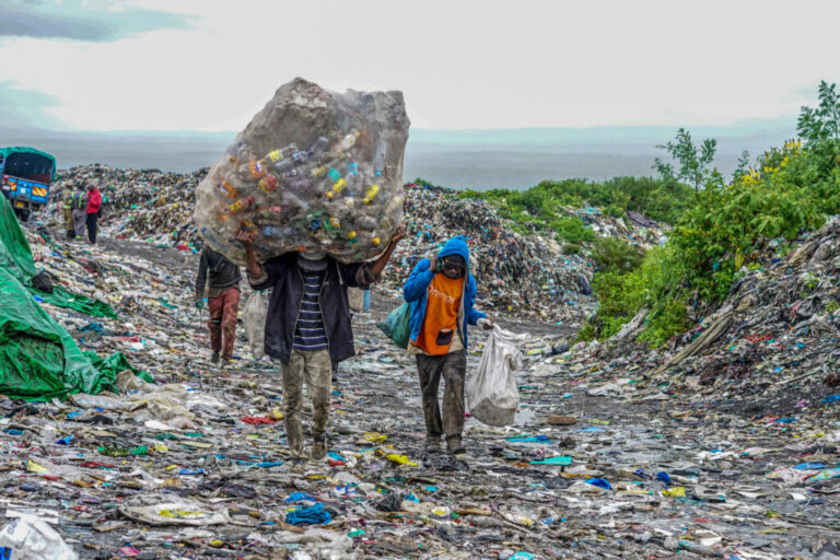 Waste pickers carry plastic materials to recycle at the Gioto dumping site in Nakuru, Kenya. Credit: James Wakibia/SOPA Images/LightRocket via Getty Images