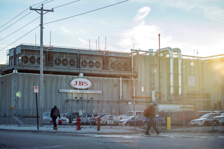 Employees walk past the JBS plant in Marshalltown, Iowa. A new report lists the Brazilian meat giant as a top five greenhouse gas emitter. Credit: KC McGinnis/The Washington Post via Getty Images