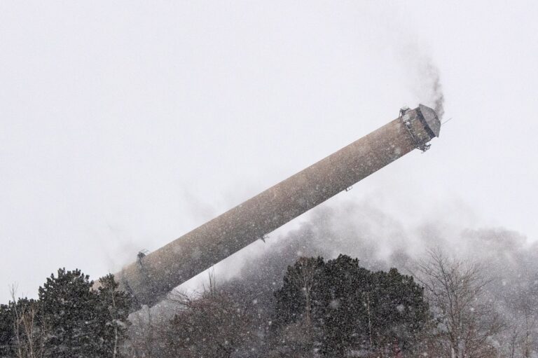 A smoke tower falls to the ground during a snow storm