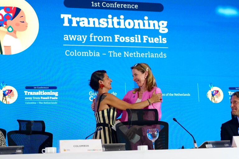 The climate and environment ministers of Colombia and the Netherlands, which are co-hosting the Santa Marta conference, embrace on the podium during the high-level segment in Santa Marta, Colombia