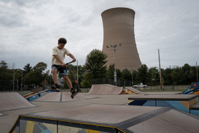 Environmental and Public Health Organizations File Lawsuit Against Trump Administrations - Creation Covenant Alliance A child plays on a scooter in the park, with the cooling tower looming in the background.