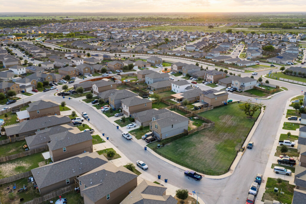 The Thompson Callaway Spears #1 well, located on the vacant lots enclosed by black metal fencing, stands next to homes inside the Preserve at Medina subdivision in southwest San Antonio. Credit: Sam Owens/San Antonio Express-News